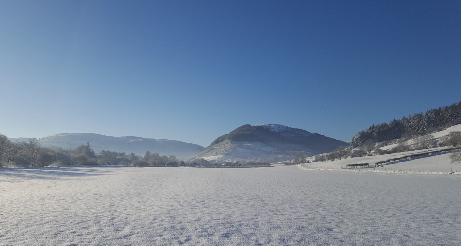 Snow-covered fields leading to the village of Penmachno Snow-covered fields leading to the village of Penmachno